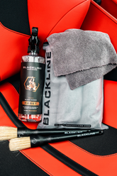 Blackline Car Care RESET interior cleaner and scent booster bottle on Ferrari F12 seat, showcasing the product&