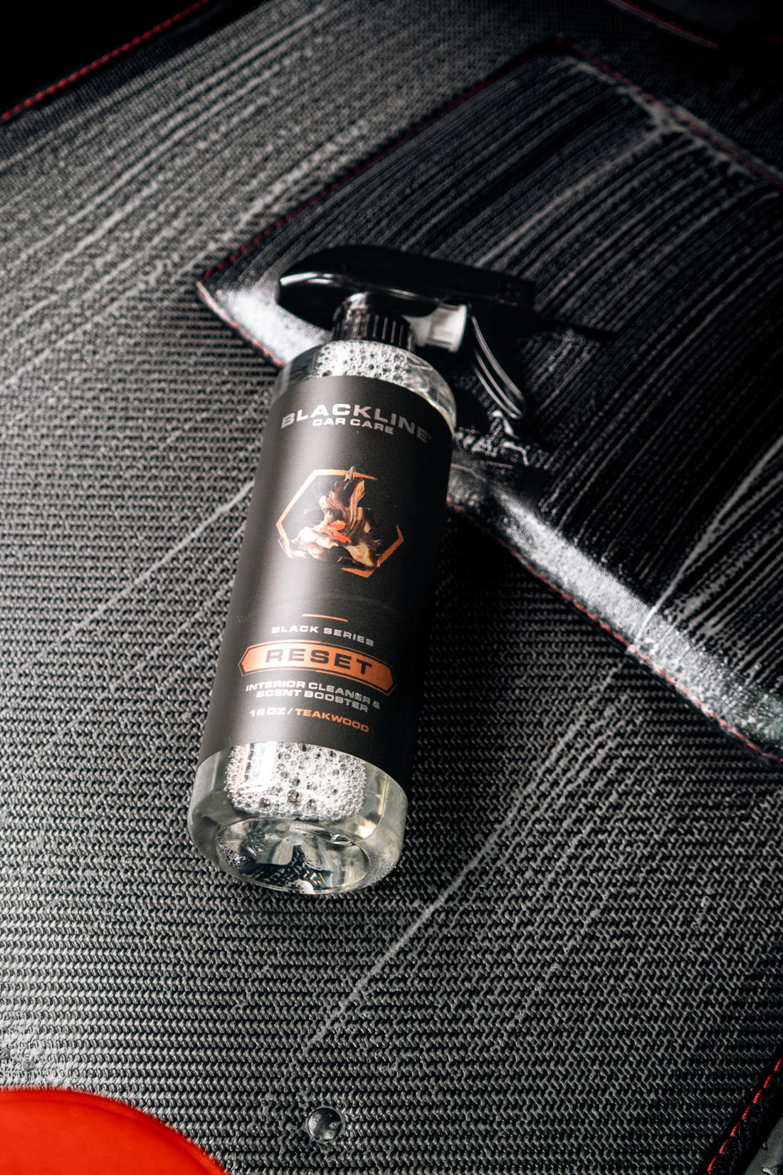 Blackline Car Care RESET interior cleaner and scent booster bottle, featuring a sleek black design with a teakwood scent label.