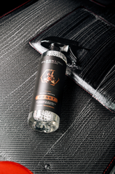 Blackline Car Care RESET interior cleaner and scent booster bottle, featuring a sleek black design with a teakwood scent label.