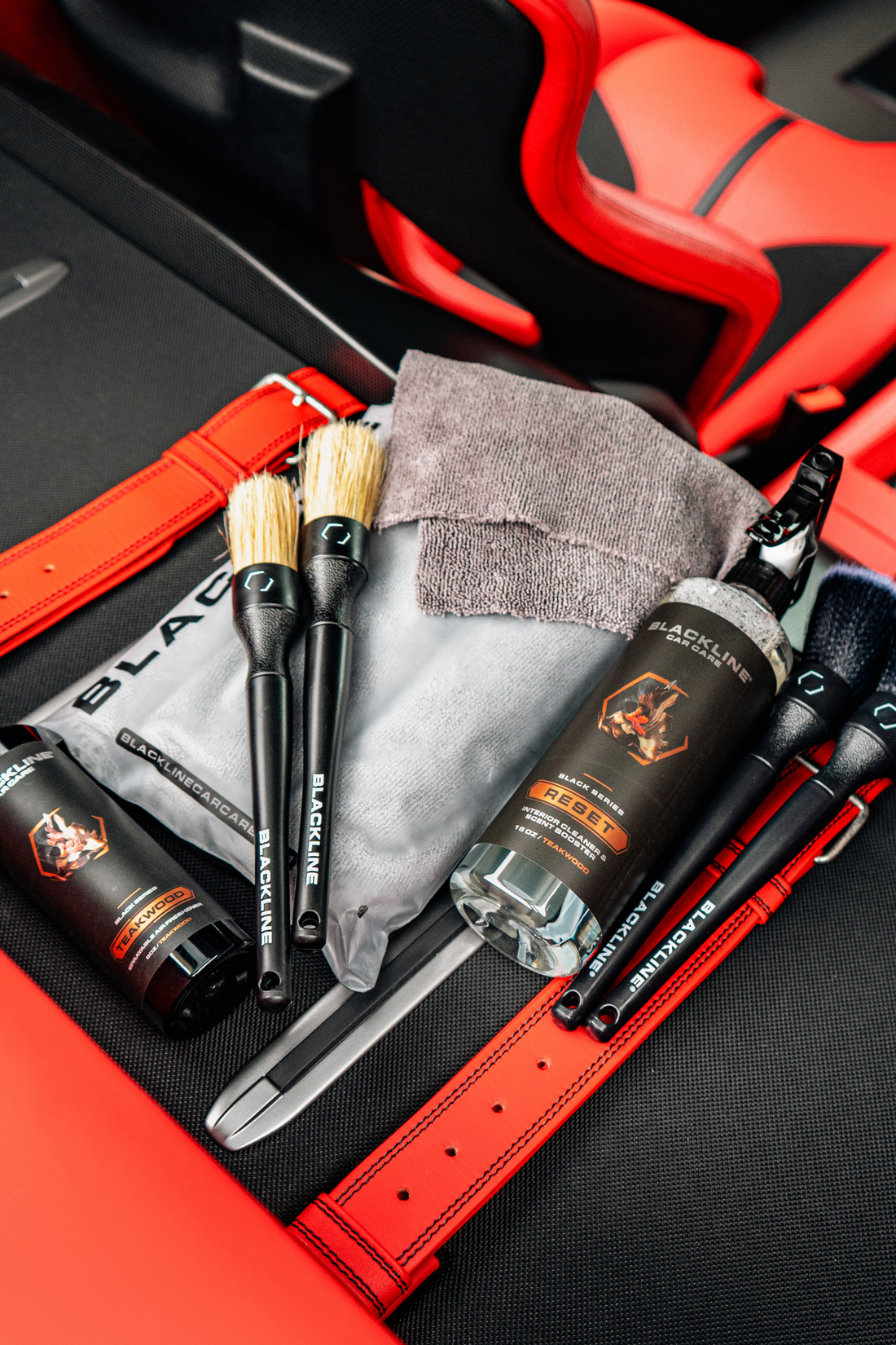 Blackline CAR CARE BLACKLINE® RESET interior cleaner and scent booster bottle inside the trunk of a Ferrari F12.