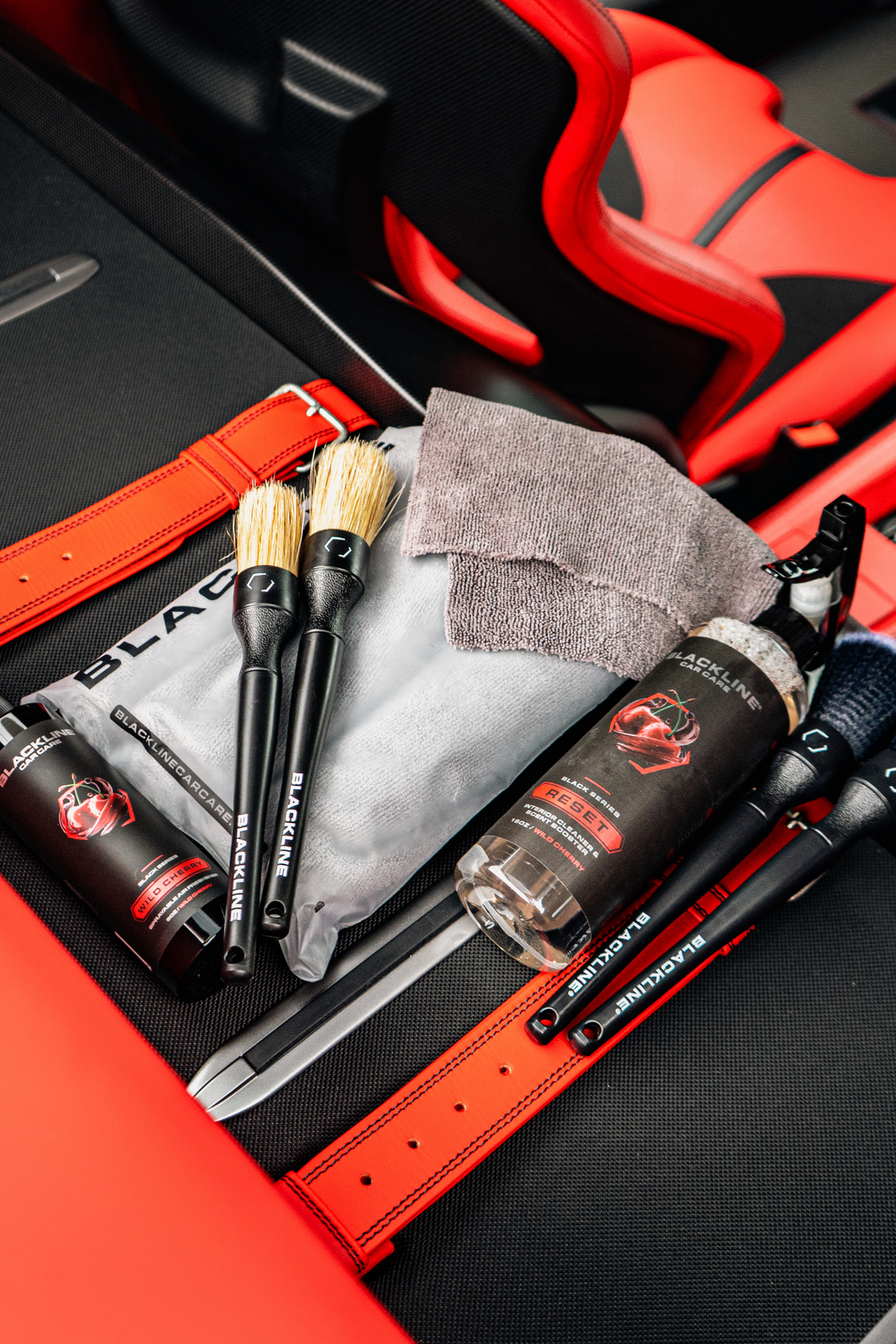 Blackline CAR CARE RESET interior cleaner and scent booster bottle inside a Ferrari F12 trunk with wild cherry scent