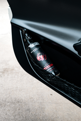 Blackline Car Care BLACKLINE® RESET interior cleaner and scent booster applied to a vehicle door panel with wild cherry fragrance.