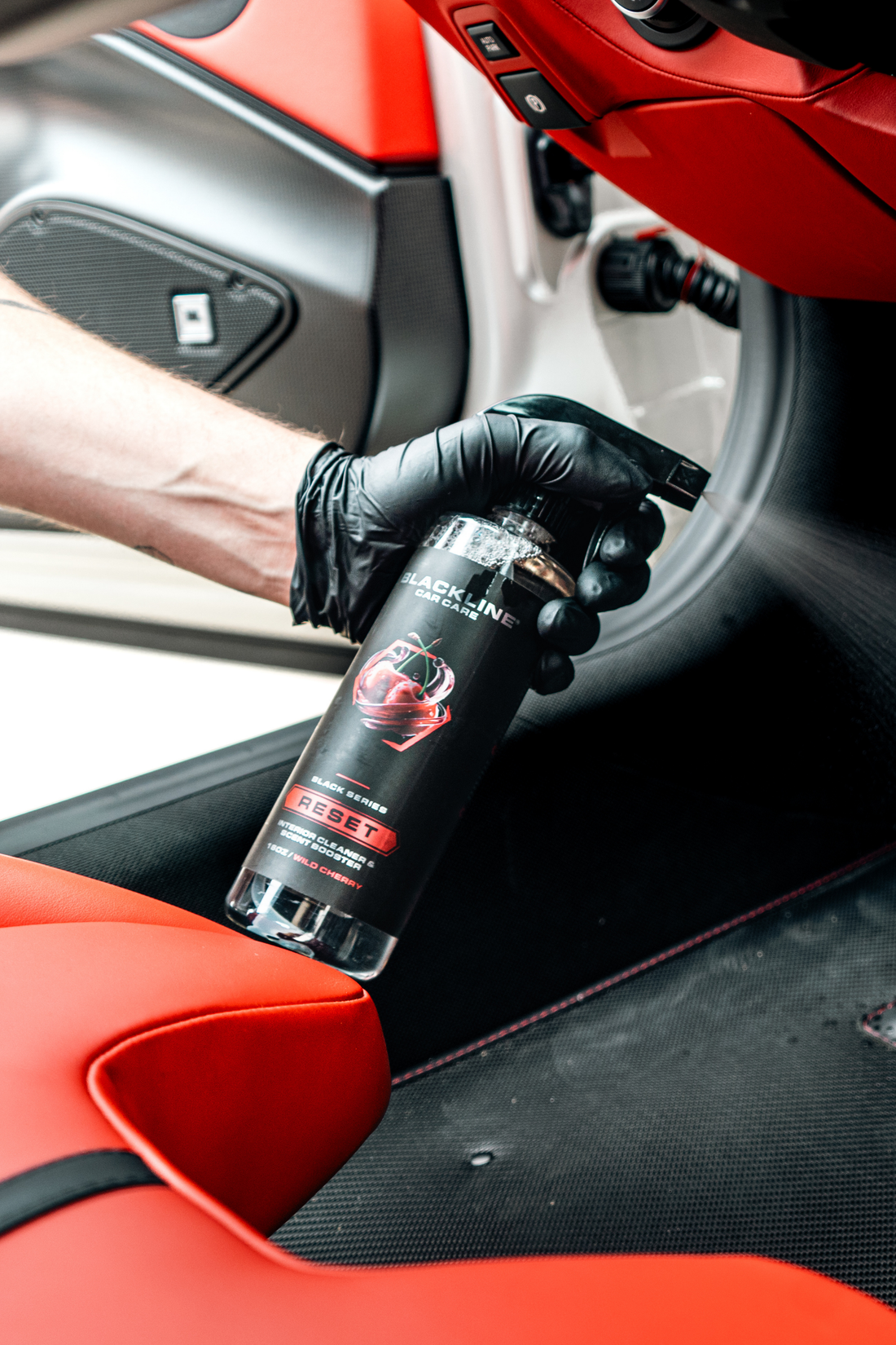 Blackline Car Care BLACKLINE® RESET interior cleaner and scent booster spray with wild cherry scent, showing the spray bottle and label.