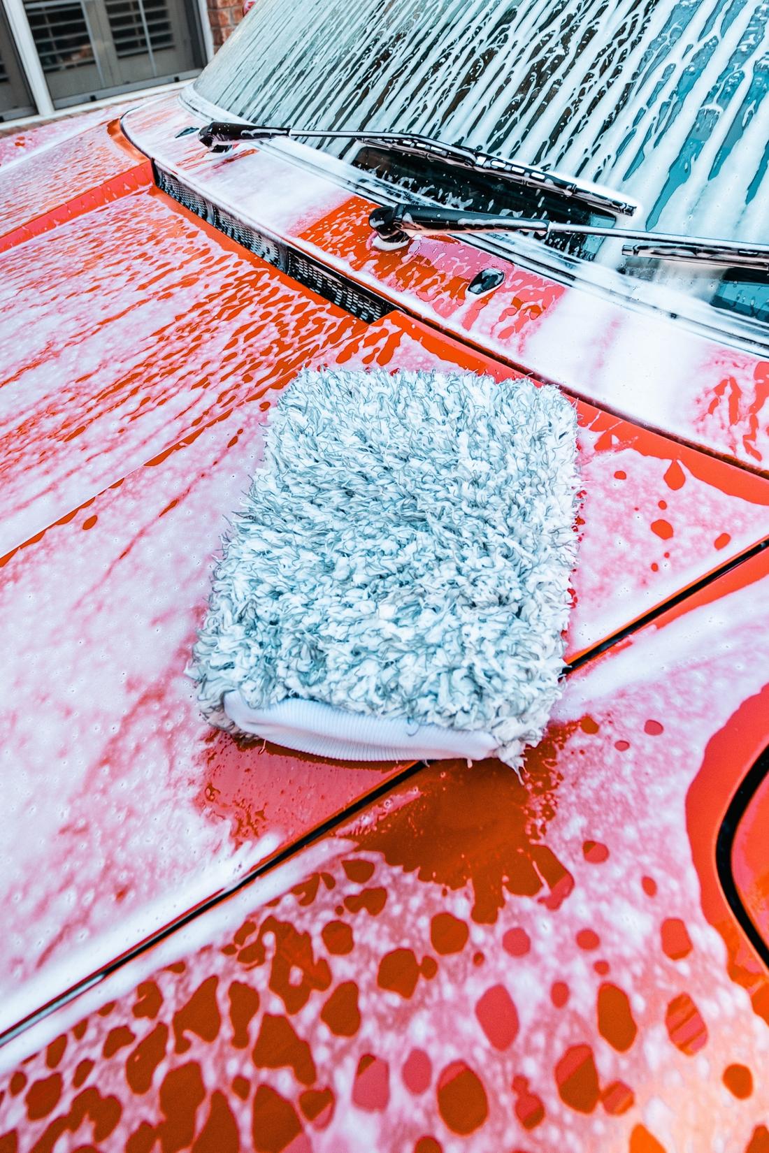 Blackline Car Care BLACKLINE® microfiber wash mitt used for car washing, showing soft microfiber material and flexible design.
