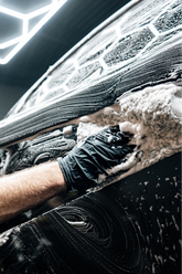 Blackline Car Care BLACKLINE microfiber wash mitt in use, showing soft, plush texture for gentle vehicle cleaning.