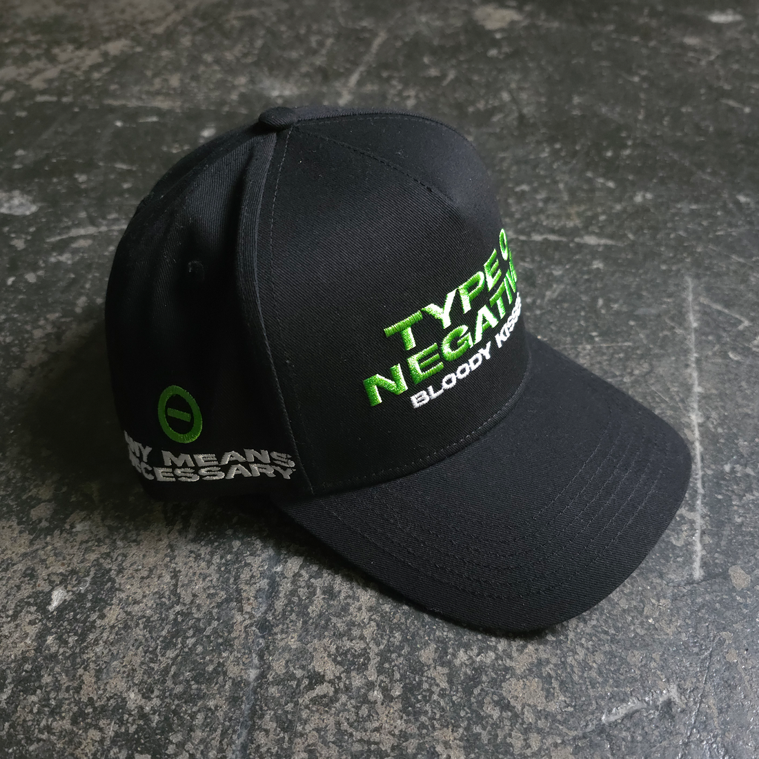 Black Bloody Kisses hat by Any Means Necessary Clothing, featuring a graphic design with blood kiss imagery.