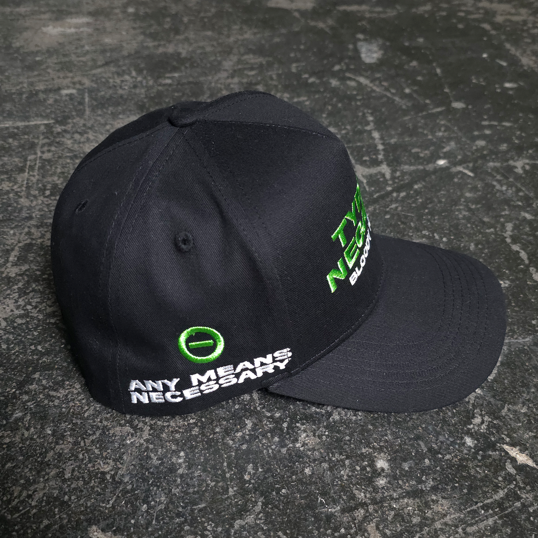 Black Bloody Kisses hat with red and white graphic design from Any Means Necessary Clothing, featuring a casual, stylish accessory.