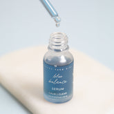 Blue Balance Face Serum by Pretty Farm Girl, showcasing a sleek blue bottle with a dropper applicator for skincare.