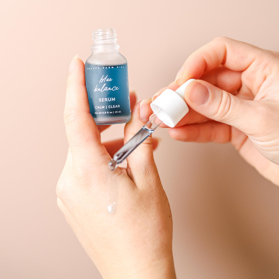 Blue Balance face serum by Pretty Farm Girl, featuring a sleek blue bottle with a dropper cap for skincare application.