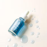 Blue Balance Face Serum by Pretty Farm Girl, featuring a sleek blue bottle with a dropper, designed for skincare and hydration.