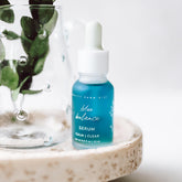 Blue Balance Face Serum by Pretty Farm Girl, featuring a sleek blue bottle with a dropper for skincare.