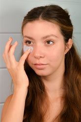 Pretty farm girl Blue Beauty Cream soothing face cream being applied to skin, highlighting its calming and hydrating properties.