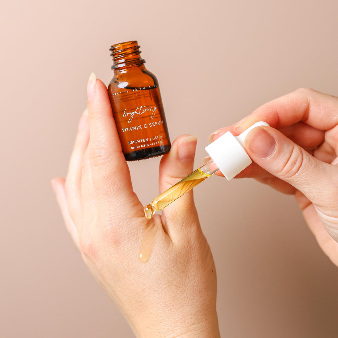 Pretty Farm Girl Brightening Vitamin C Face Serum bottle with dropper, showcasing the product&
