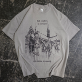 Grey Chapel T-Shirt from Any Means Necessary Clothing featuring a front view of the casual shirt with a simple design.