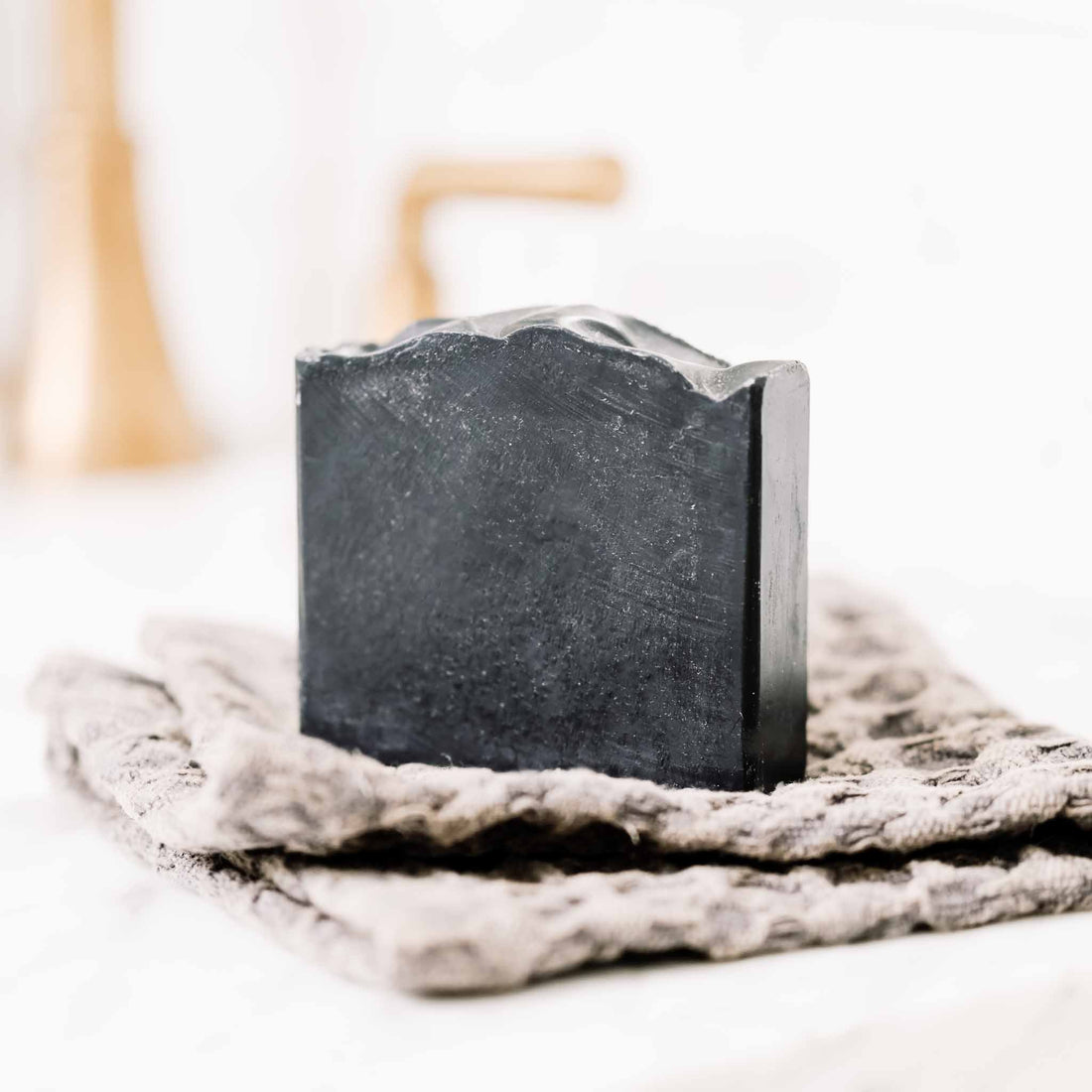 Handmade charcoal bar soap with tallow and goat milk, natural skincare product by Pretty Farm Girl, showing the soap&