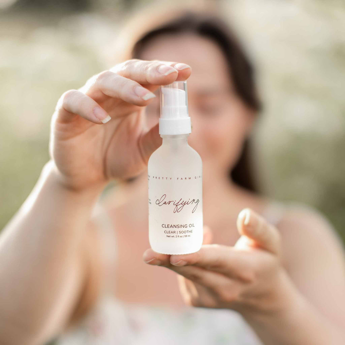 Pretty Farm Girl clarifying cleansing oil for acne-prone skin, showing a bottle of face cleanser with natural ingredients.