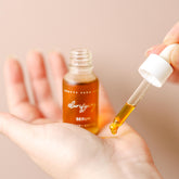Bottle of Pretty Farm Girl clarifying face serum for acne-prone skin with dropper applicator on a white background.