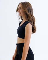 Black Downeast Contour Demi Tee displayed on a hanger, showcasing its fitted, casual style and soft fabric.