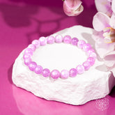 Pink Kunzite bracelet with heart-shaped charms from Conscious Items, showcasing delicate pink stones and intricate design.