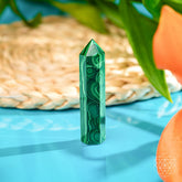 Malachite phoenix sculpture by Conscious Items, a striking home decor piece with vibrant green and black stone details.