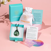 Seraphinite pendant necklace called The Angel by My Side from Conscious Items, featuring a polished, green and silver-toned gemstone.
