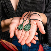 Seraphinite pendant necklace called The Angel by My Side from Conscious Items, featuring a polished, deep green gemstone on a silver chain.
