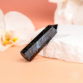Rare Arfvedsonite point home decoration by Conscious Items, showcasing polished gemstone with deep blue and black hues.