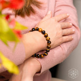 Conscious Items Tiger’s Eye bracelet featuring polished 7A grade stones, strung on an elastic band for a stylish, natural look.