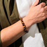 Conscious Items Tiger’s Eye bracelet featuring 7A Grade polished tiger’s eye beads on an elastic cord.