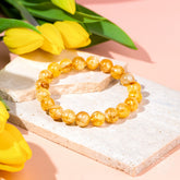 Golden Healer Quartz bracelet from Conscious Items featuring polished golden crystal beads on an elastic stretch band.
