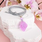 Pink Kunzite pendant necklace by Conscious Items featuring a large pink gemstone on a delicate chain.