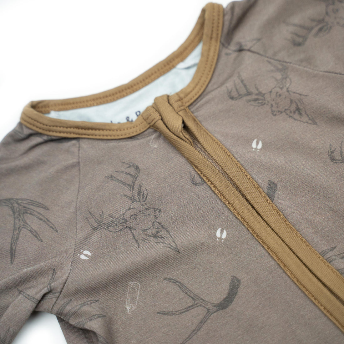 Baby Zippy from Bow Crew Apparel Racks &amp; Rattles collection, featuring colorful, soft baby clothing with playful designs and branding.