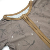 Baby Zippy from Bow Crew Apparel Racks & Rattles collection, featuring colorful, soft baby clothing with playful designs and branding.