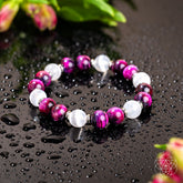 Pink Galaxy Tiger’s Eye bracelet from Conscious Items featuring vibrant pink and tiger’s eye beads on a stylish bracelet design.