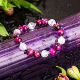 Pink Galaxy Tiger’s Eye bracelet by Conscious Items featuring polished tiger’s eye stones on a vibrant pink background.