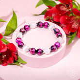 Pink galaxy tiger’s eye bracelet from Conscious Items featuring vibrant pink and earthy tiger’s eye beads on a stylish bracelet.