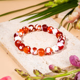 Feminine Force Carnelian Orca Agate bracelet by Conscious Items featuring vibrant orange and patterned stone beads.