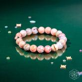 Peruvian pink opal bracelet by Conscious Items featuring polished pink stones on a delicate elastic cord.