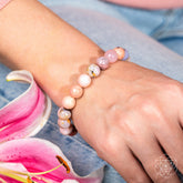 Peruvian Pink Opal bracelet by Conscious Items featuring pink gemstone beads on a stretchy cord.