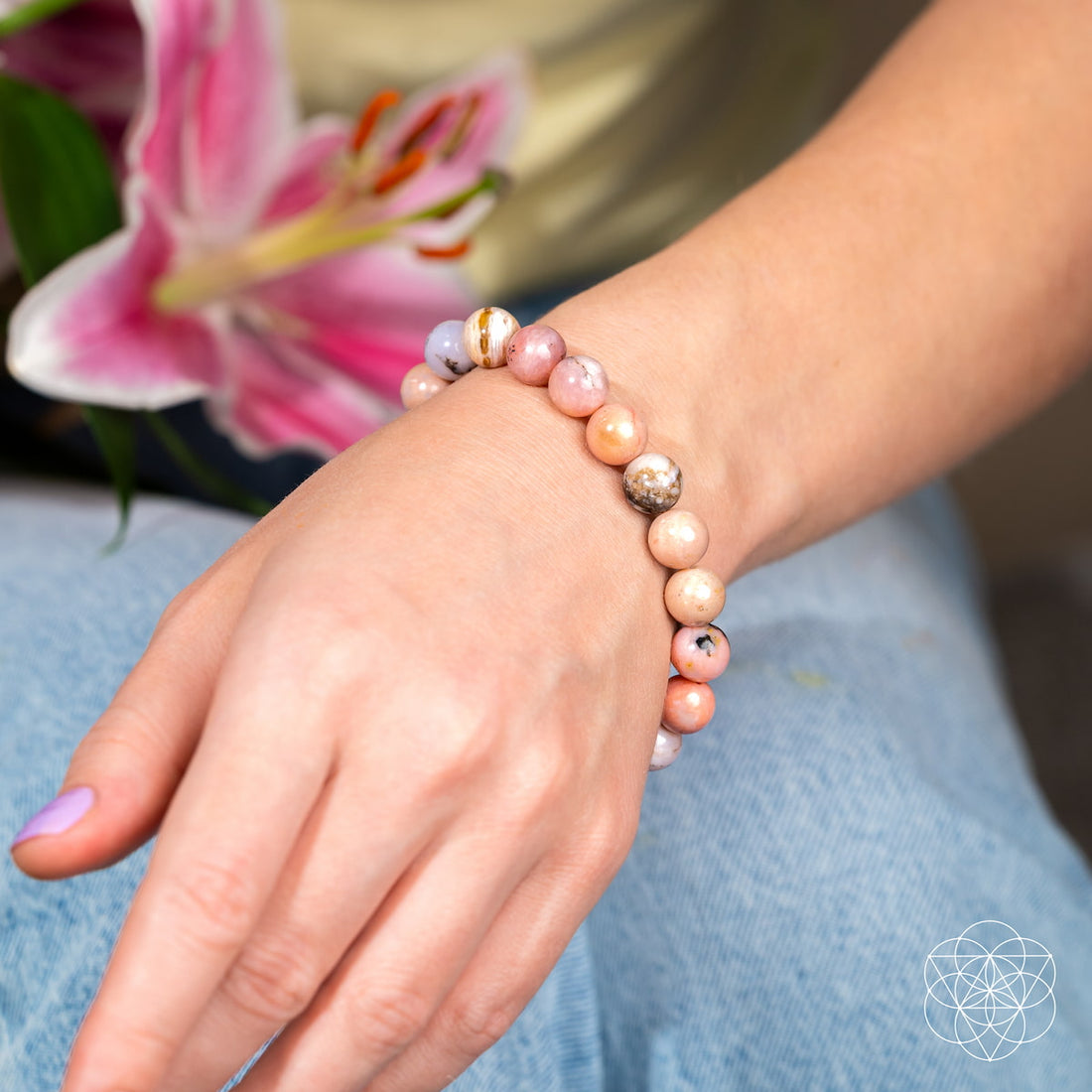 Peruvian pink opal bracelet by Conscious Items featuring polished pink stones on a delicate elastic band.