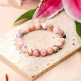 Peruvian pink opal bracelet by Conscious Items featuring polished pink stone beads on a stretch cord.