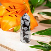 Spiritual Bodyguard Snowflake Obsidian point home decoration by Conscious Items, showcasing polished black stone with white snowflake patterns.