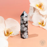 Spiritual Bodyguard Snowflake Obsidian Point home decoration by Conscious Items, featuring a black stone with white snowflake patterns.
