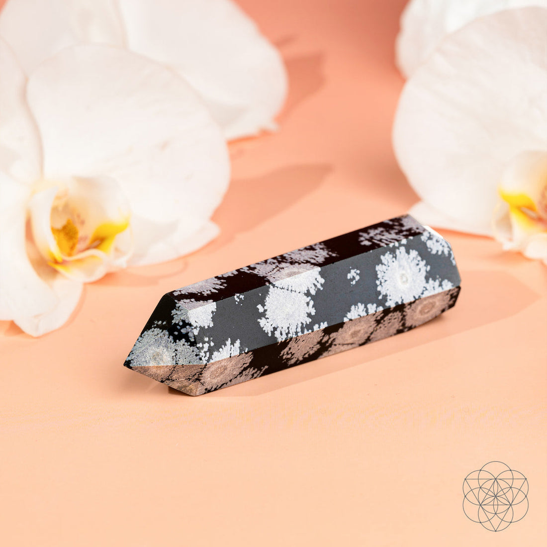 Snowflake Obsidian Point home decoration by Conscious Items, showcasing a polished spiritual crystal with distinctive white snowflake patterns.