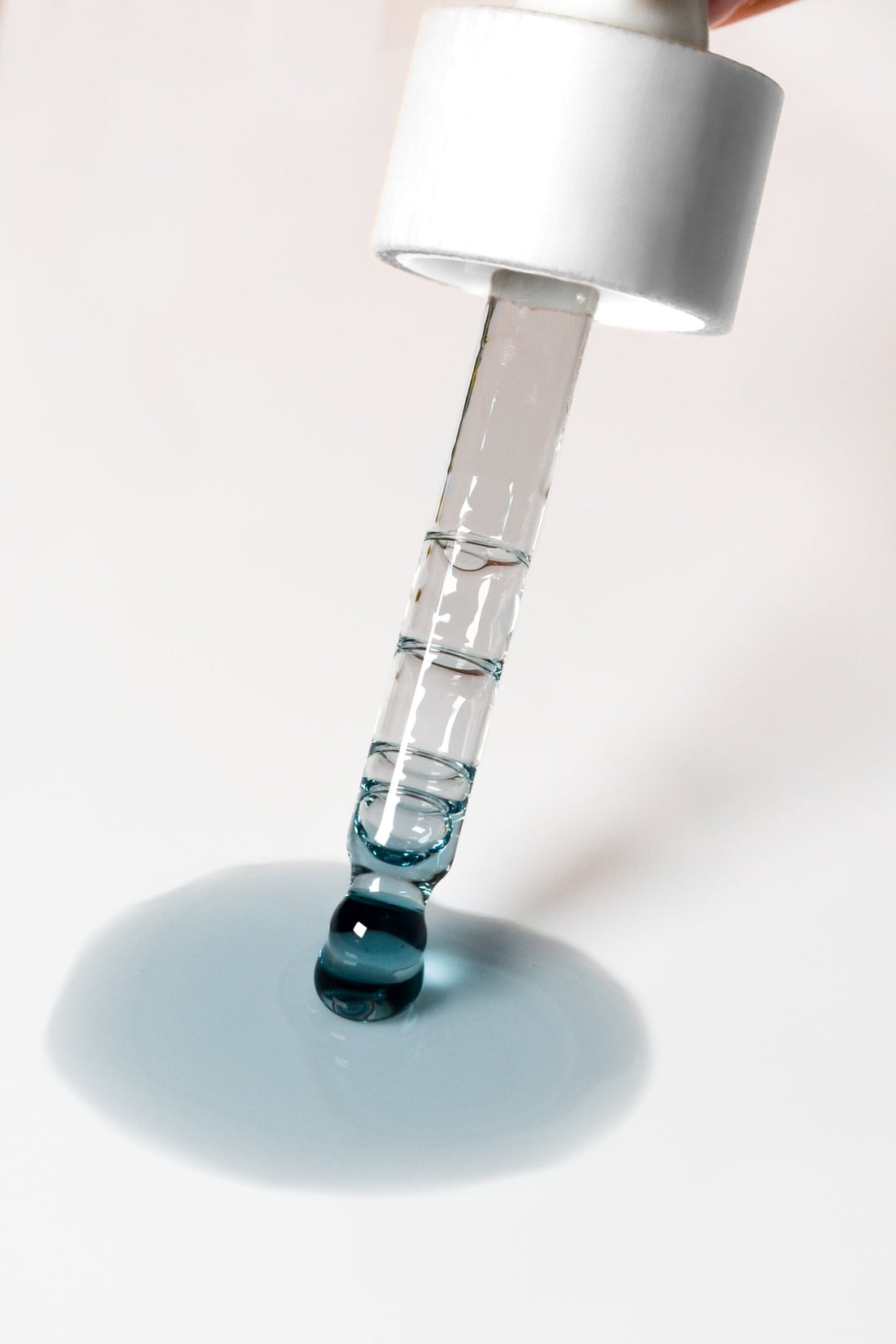 Blue Balance Face Serum by Pretty Farm Girl, close-up of the serum bottle with a sleek blue design and dropper cap.