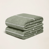 Italic Deia Australian cotton bath towel displayed in a cozy home setting, showcasing soft, plush texture and elegant design.