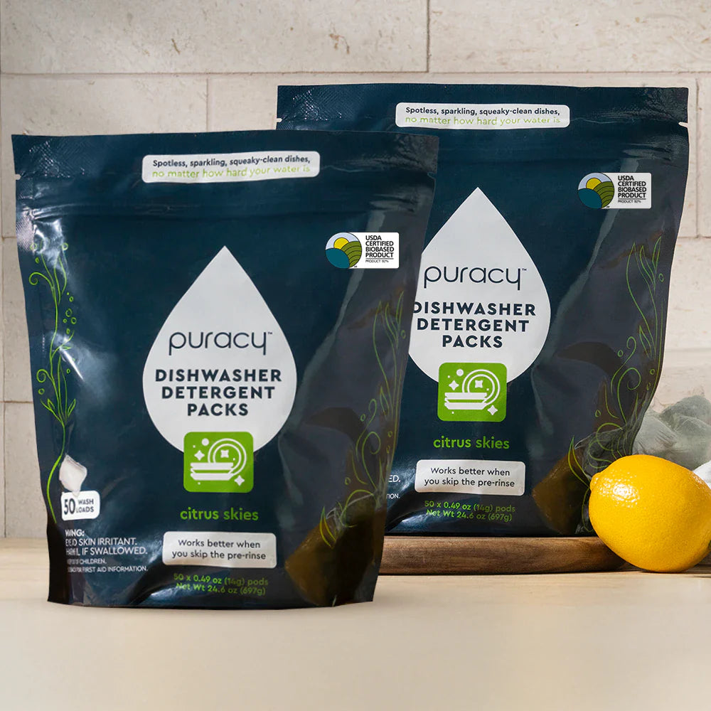 Puracy dishwasher detergent pods in Citrus Skies scent, 50 count, two-pack, showing bright citrus-themed packaging and pods.