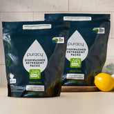 Puracy dishwasher detergent pods in Citrus Skies scent, 50 count, two-pack, showing bright citrus-themed packaging and pods.