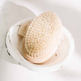Pretty Farm Girl dry body brush for exfoliating and skincare, featuring natural bristles and ergonomic handle.