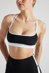 Black and white electric rib color block bra by Fitkitty Culture, designed for women’s athleisure and yoga wear.